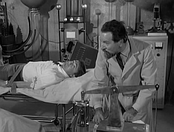 Fugitive Nazi scientist Prof. Amadeus about to drain Napoleon Solo of his blood in The Deadly Games Affair.